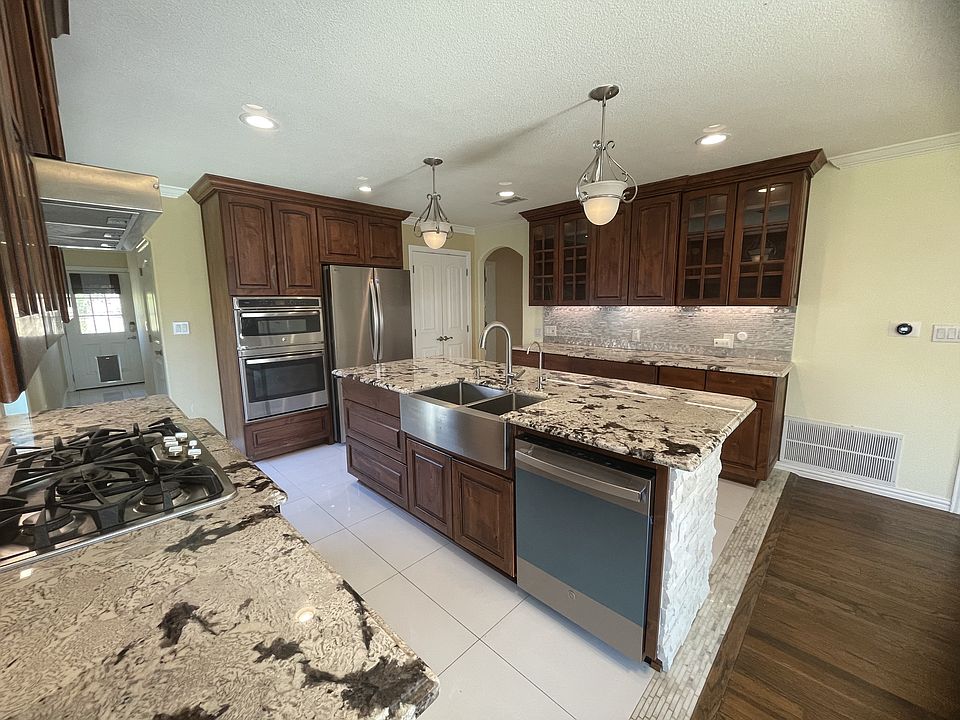 Kitchen with modern stainless steel appliances and granite counter tops.