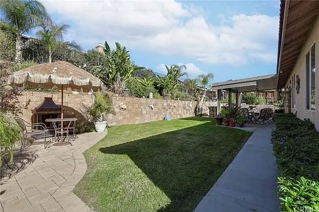 Back Yard. Far right is the island which includes a grill and an outdoor fire place. Outdoor TV