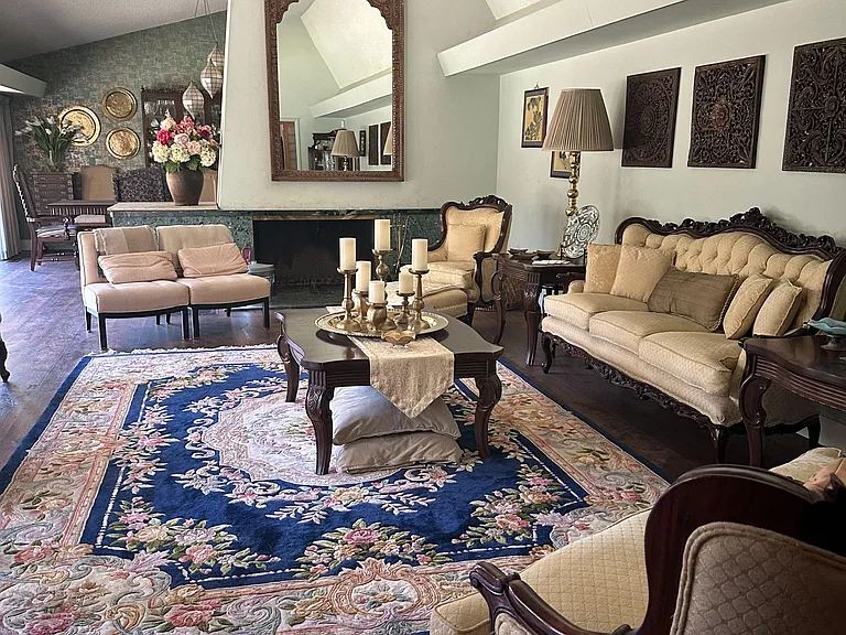 Spacious living room with vaulted ceilings, fireplace focal point, and multiple seating areas for relaxing or entertaining.