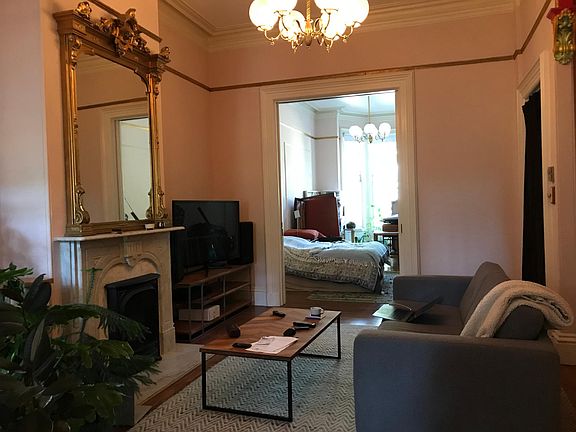 Living room opens to bedroom with large pocket doors