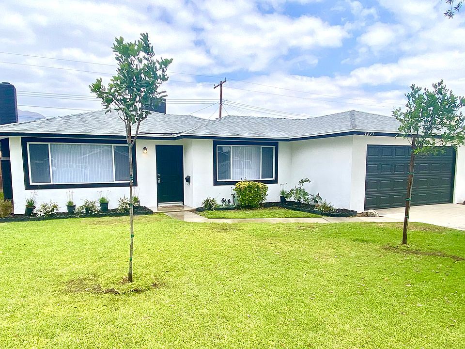 Front exterior with automatic sprinklers, newly planted trees and shrubs. New roof. Gardener included with rent.
