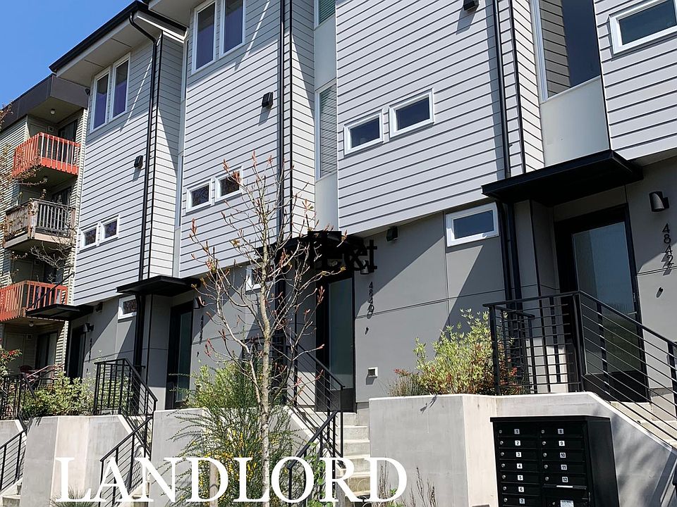 Front of property with 12 townhouses. All mailboxes out front. 4846-A is tucked away in back on NE corner.