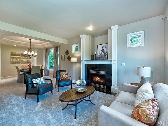 Step into the formal living room and dining area with a cozy gas fireplace.