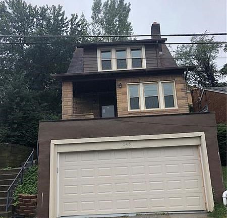 The over sized 2 car attached garage has steps that lead to the basement.