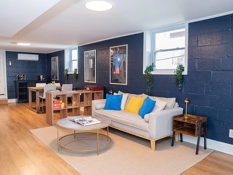 Spacious open-concept dining and living room area filled with tons of natural light.