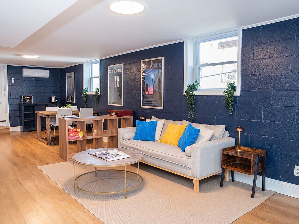 Spacious open-concept dining and living room area filled with tons of natural light.