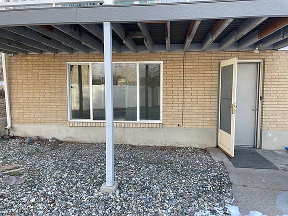 View of Basement Walk-out entry featuring large windows to basement living room.