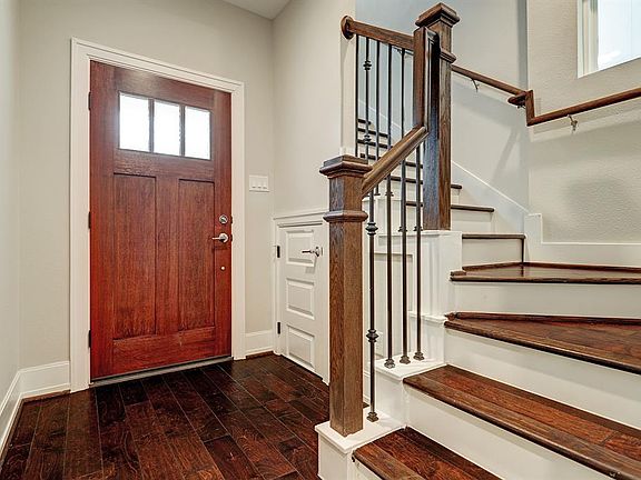 Foyer/front entry with gorgeous wood floors and stairs