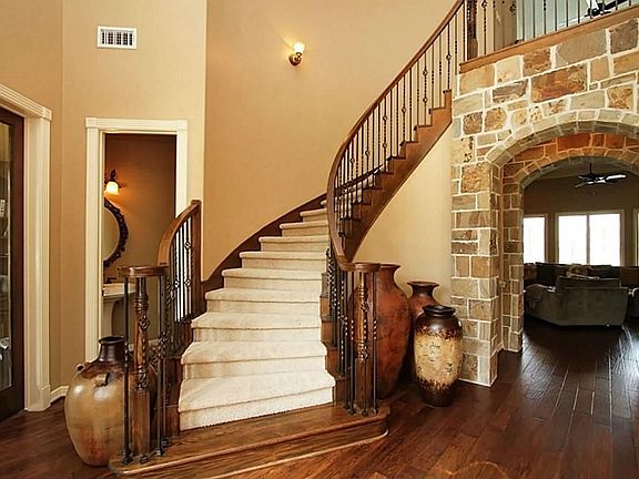 Spectacular sweeping staircase is the focal point in this grand entrance.