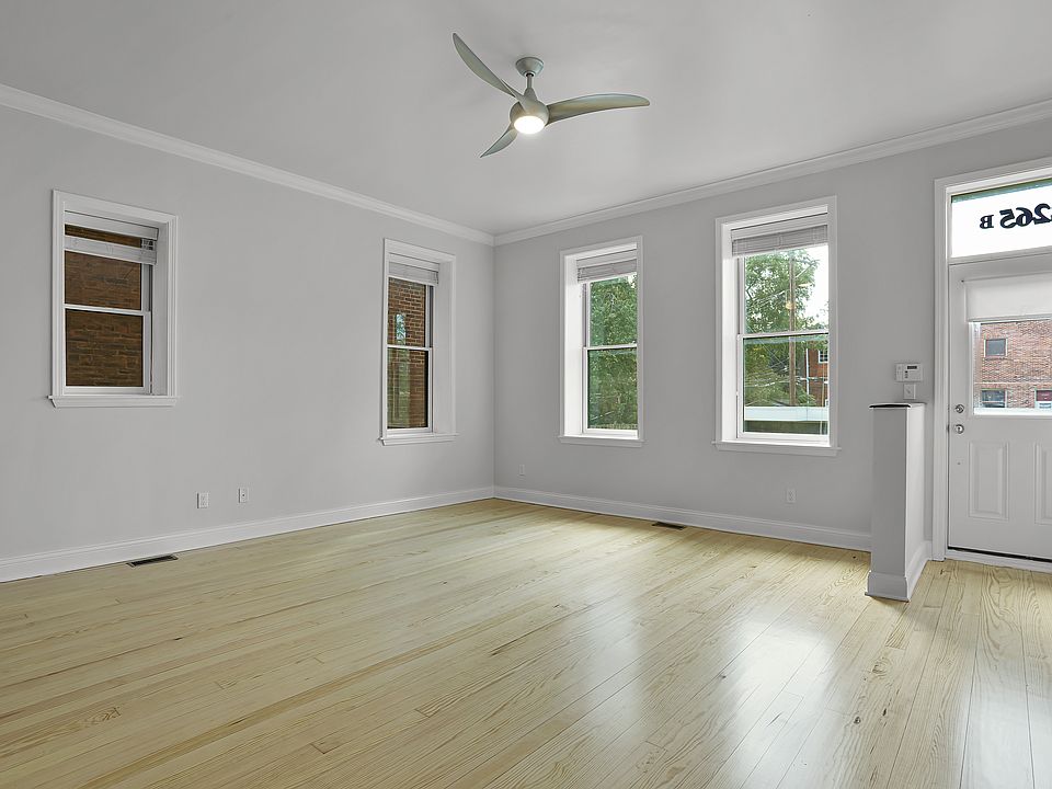 family room: elegant ceiling fan, gorgeous wood floors, crown moulding