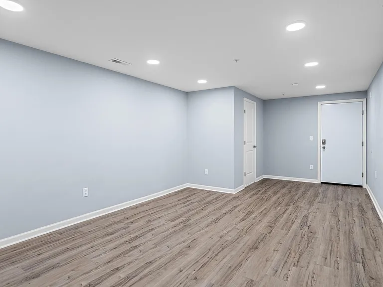 Living space looking at the powder room in the corner and second entry door.
