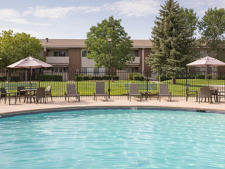 Shaded tables surrounding the pool