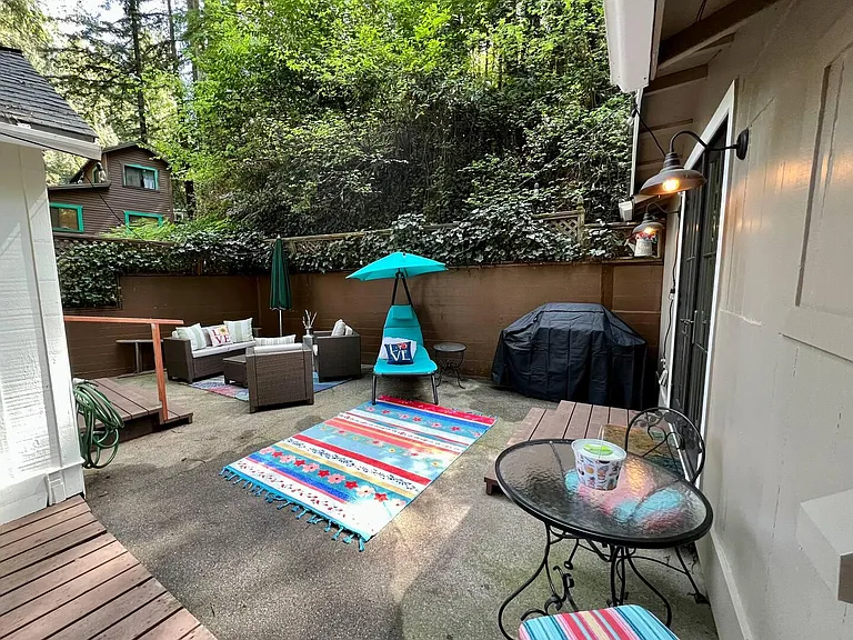View of concrete patio from deck.