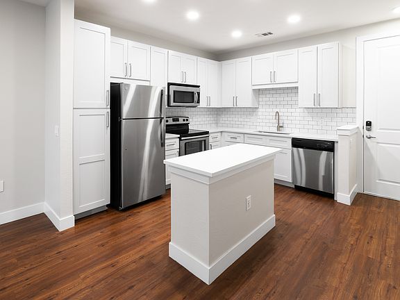 New kitchens with stainless steel appliances and white quartz countertops