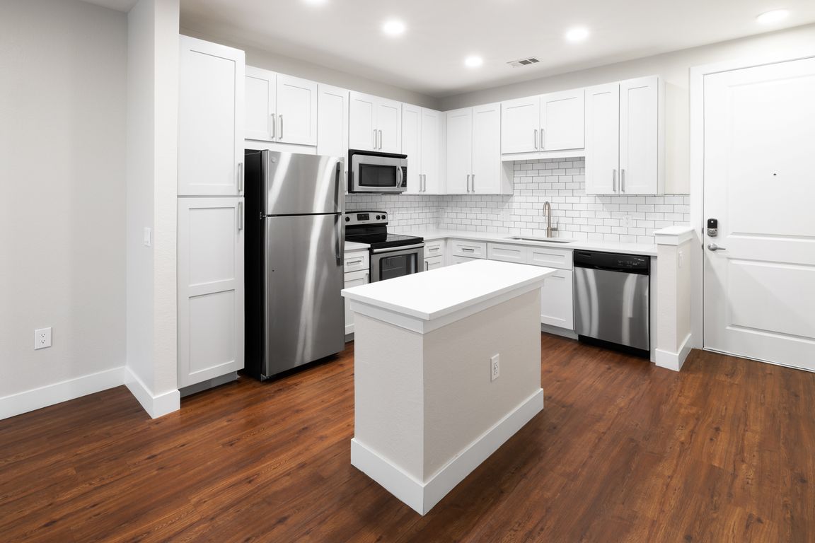 New kitchens with stainless steel appliances and white quartz countertops