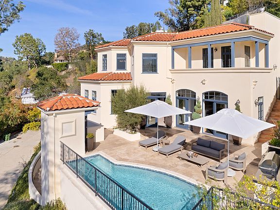 The deck and pool area offer a perfect space for sunbathing or relaxing with a good book