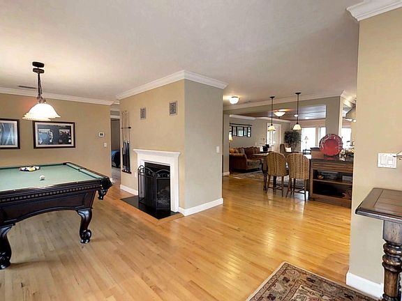 Game room with pool table and fireplace