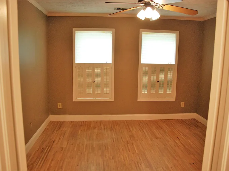 Main-level flex room with door, window, and closet _ works as office, den, guest room, dining room, or third bedroom.