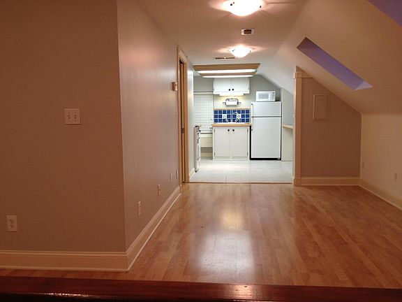Living room. Wood floors, skylights. Cable and fiberoptic ready. Kitchen in the distance.