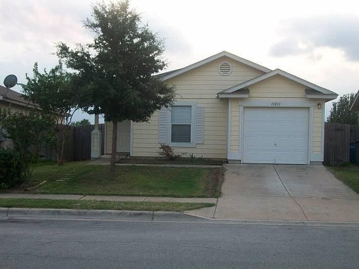 Front yard with one car garage with garage door opener