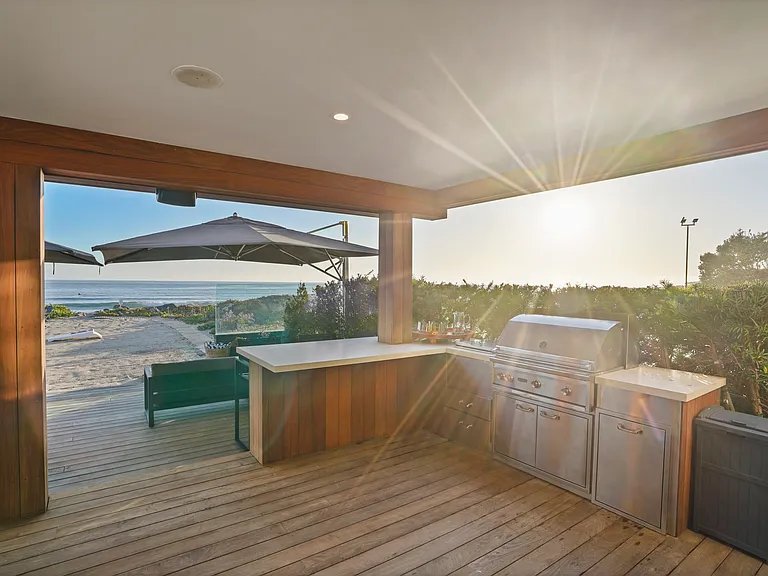 A fully equipped outdoor kitchen, ready for seaside barbecues and sunset feasts.