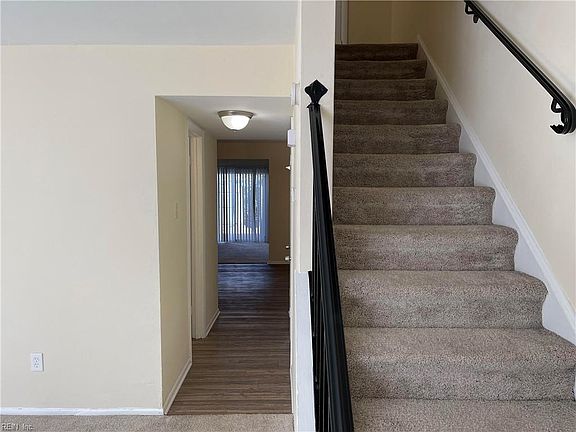 Foyer, Hallway leading to half bath, dining room/ kitchen/ family room
