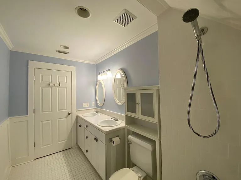Upstairs bathroom, located between the two bedrooms. It has a shower and tub, two sinks.