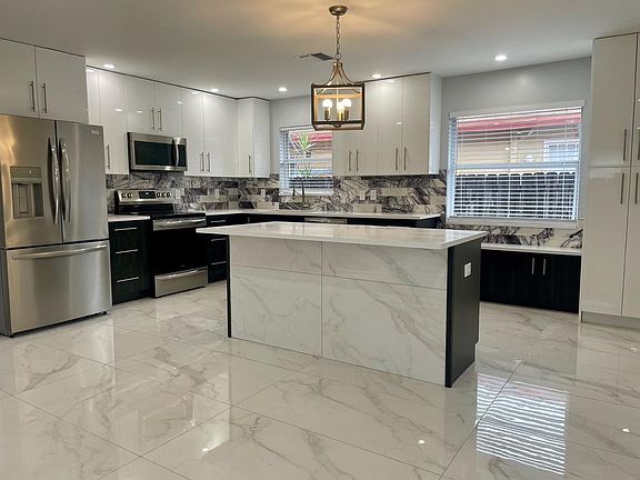 A welcoming kitchen with seating for three at the island, to engage while entertaining.