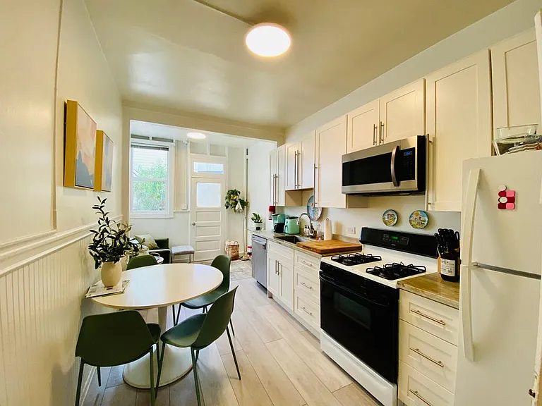 Kitchen with view of breakfast nook beyond. Great natural light.
