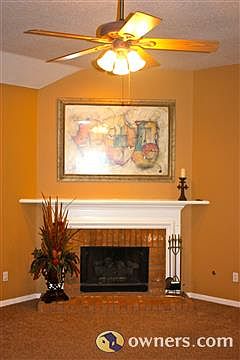 Large brick fireplace with mantle and gas logs