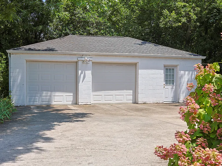To find such a spacious 2 car garage (and adjoining office space) in Crestwood is rare! The concrete parking pad is also large, and is surrounded by dozens of different types of flowers. The backyard is shaded and includes a wooden swingset.