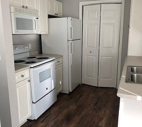 Kitchen - laundry area behind folding doors.