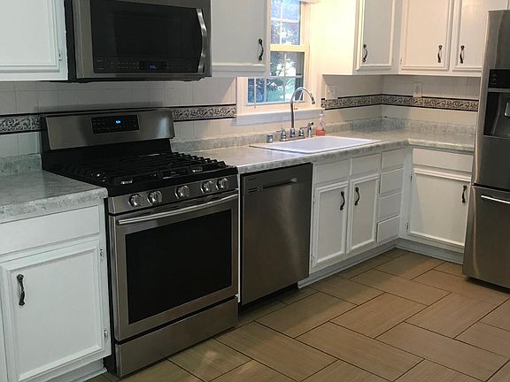 Kitchen with updated cabinets, countertops, and stainless st