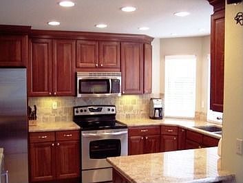 Upgraded Cherry and Stainless Steel Kitchen with Granite, stone and tile