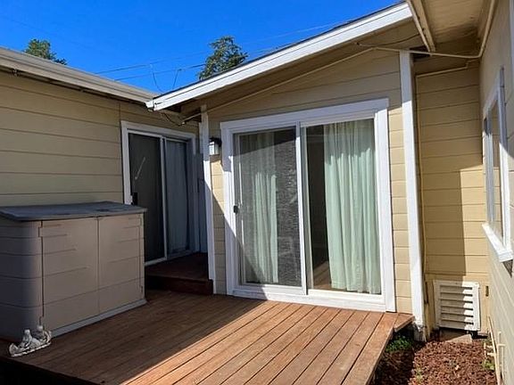 deck off bedroom, and main house to the left