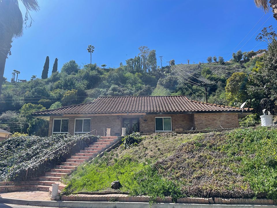 Front - Home Sits on Hillside.