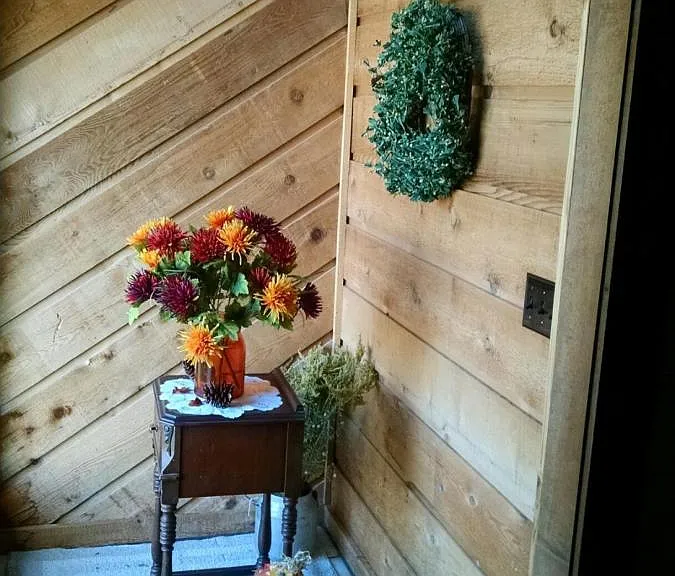 Bright and sunny nook next to the front door is perfect for a large potted plant or a Christmas tree.
