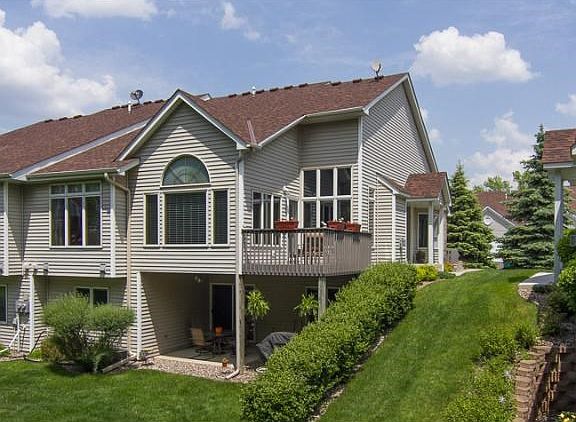 End unit walkout one level townhome with deck and patio overlooking the treeline.