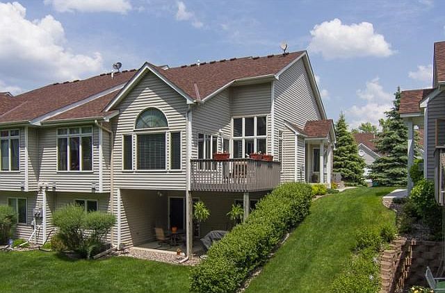 End unit walkout one level townhome with deck and patio overlooking the treeline.