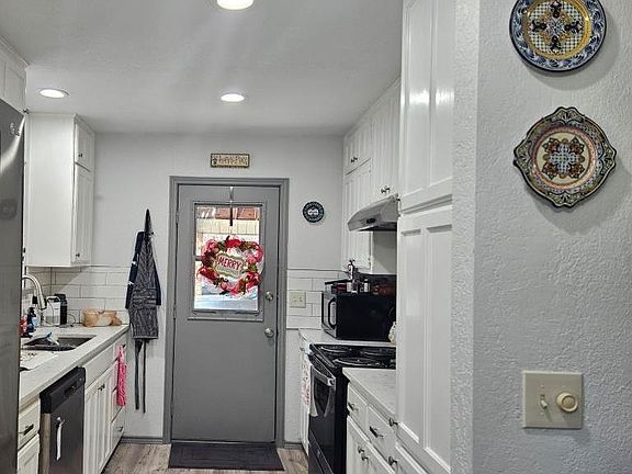 galley style kitchen with plenty of storage