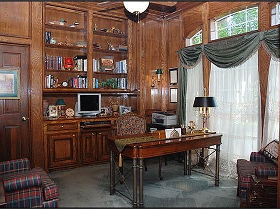  WARM INVITING STUDY WITH BEAUTIFUL MILLWORK! Custom built-in desk, pull out drawer for keyboard & book shelves. Oak wood paneled walls and wood blocked paneled ceiling with ceiling fan.