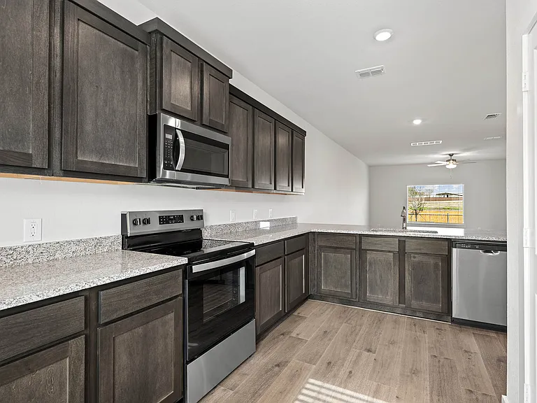 The kitchen has sprawling granite countertops.