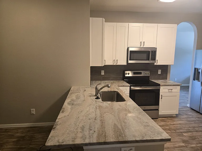 Updated gorgeous kitchen with thick beautiful upgraded granite, undermount stainless steel sink, soft close shaker upgraded cabinets, stainless steel appliances including Kitchen Aid dishwasher, LG refrigerator, GE range and microwave.