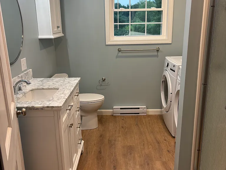 Bathroom with vanity, walk in shower and laundry