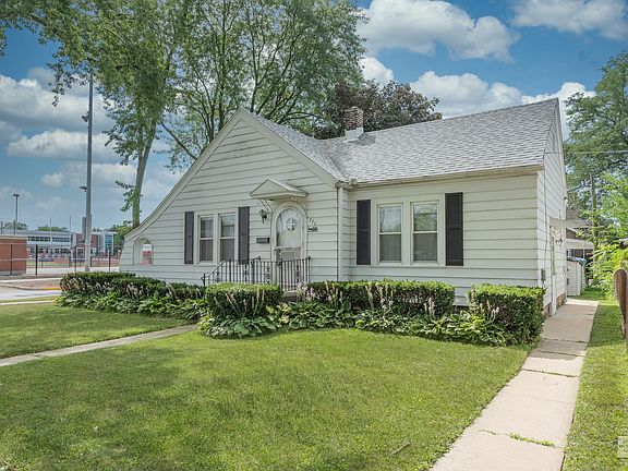 Convenient sidewalk that goes around the house, connects to the side door, and leads to the garage.