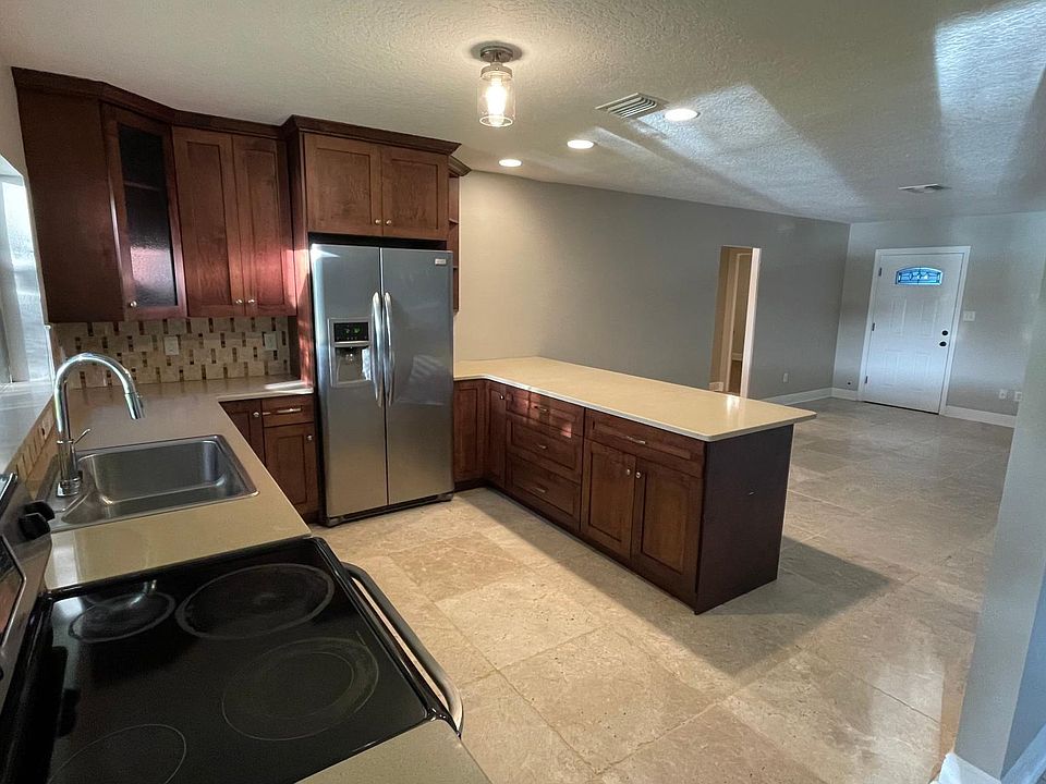 Kitchen with a modern open floor plan dining roll and living room with a fire place