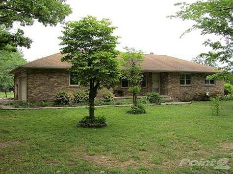 Front view of this all brick exterior home with side entry garage.
