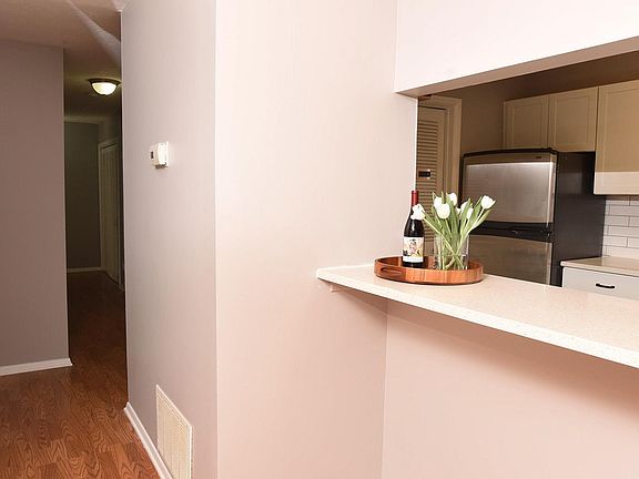 New galley kitchen has pass through bar and room for seating. Hallway to 3 bedrooms.