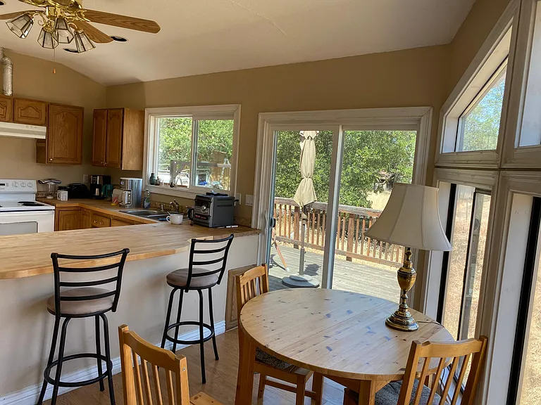 Fully equipped kitchen with eating area, two private decks and views.