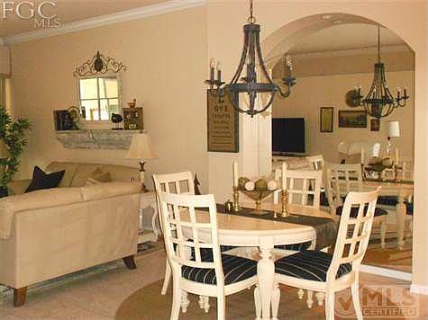 Formal dining area with custom arched mirror.  Tiled fooring in dining/living areas.  Crown molding throughout dining/living rooms.